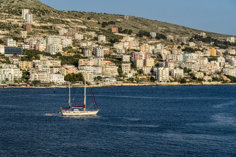 This image shows a view of the harbor at the town of Sarande in southern Albania on the Ionian Sea with the city in background